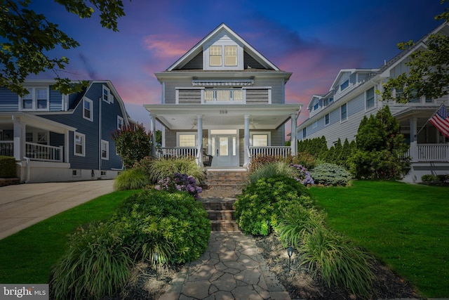 view of front of property with a yard and covered porch