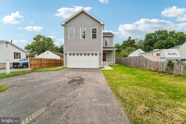 front of property with a front lawn and a garage