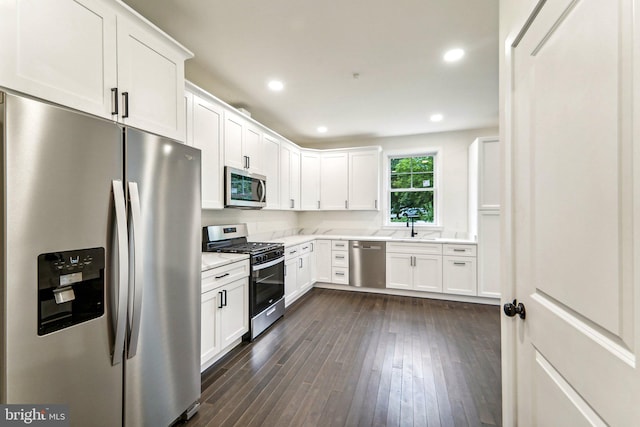 kitchen with white cabinets, dark wood-type flooring, sink, and stainless steel appliances