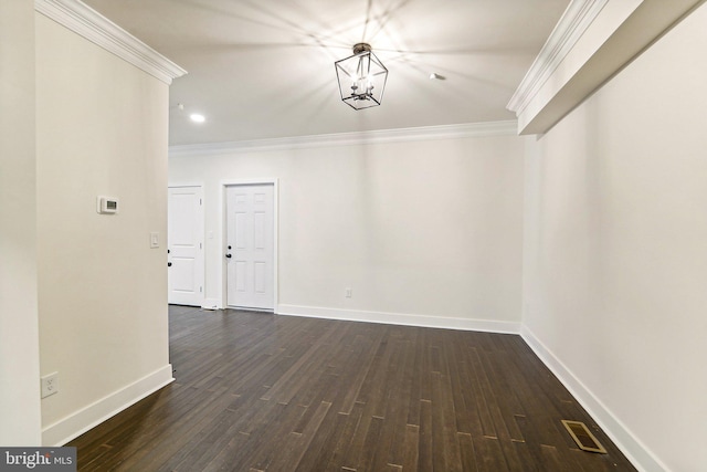 unfurnished dining area featuring ornamental molding, dark hardwood / wood-style flooring, and a notable chandelier