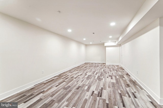 basement with light hardwood / wood-style floors