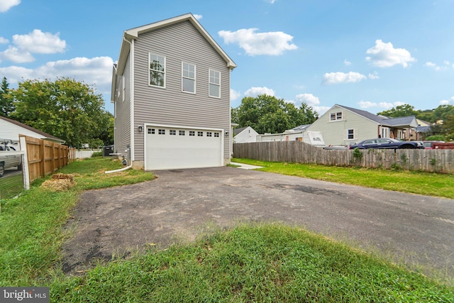 view of front of property with a front yard and a garage