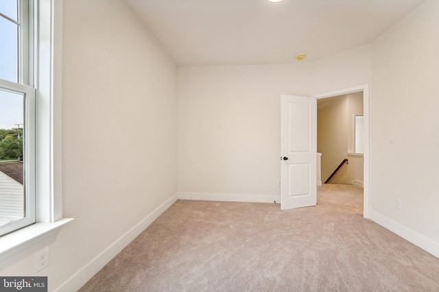 unfurnished room with light colored carpet