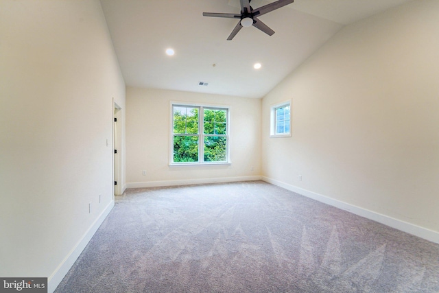 spare room with ceiling fan, carpet, and vaulted ceiling