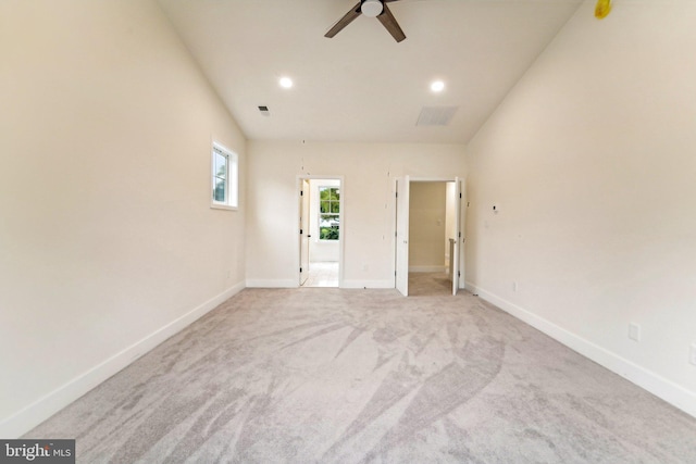 carpeted empty room featuring ceiling fan and lofted ceiling