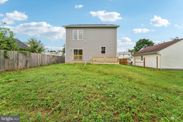 rear view of property with a lawn