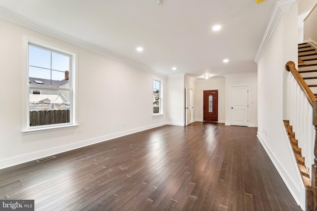 unfurnished living room featuring dark hardwood / wood-style flooring, crown molding, and a healthy amount of sunlight