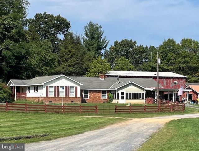 ranch-style home with a front lawn