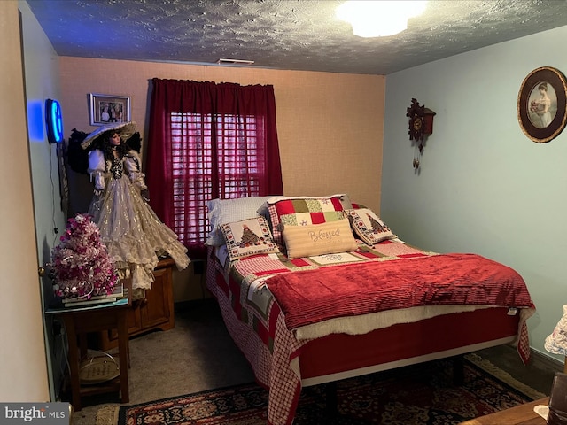 carpeted bedroom with a textured ceiling