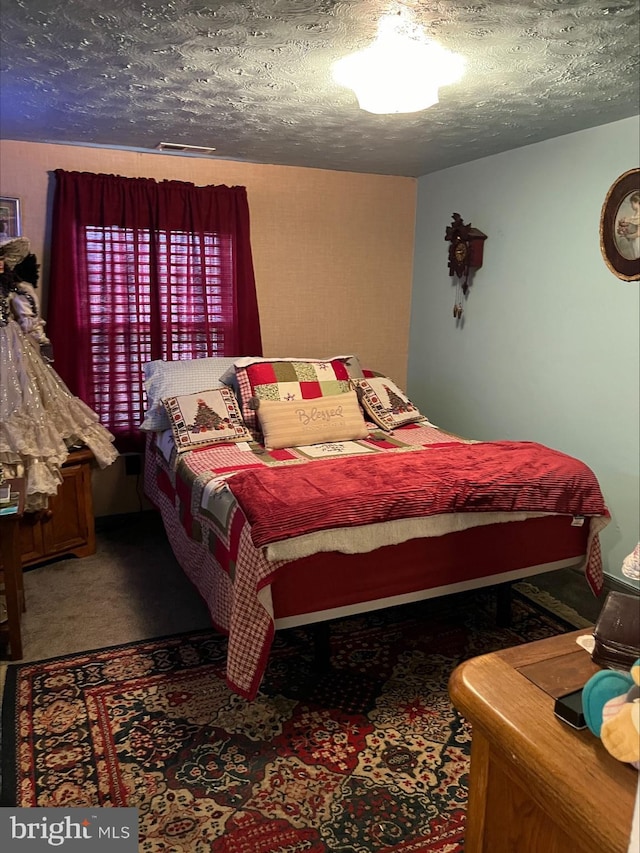 carpeted bedroom with a textured ceiling