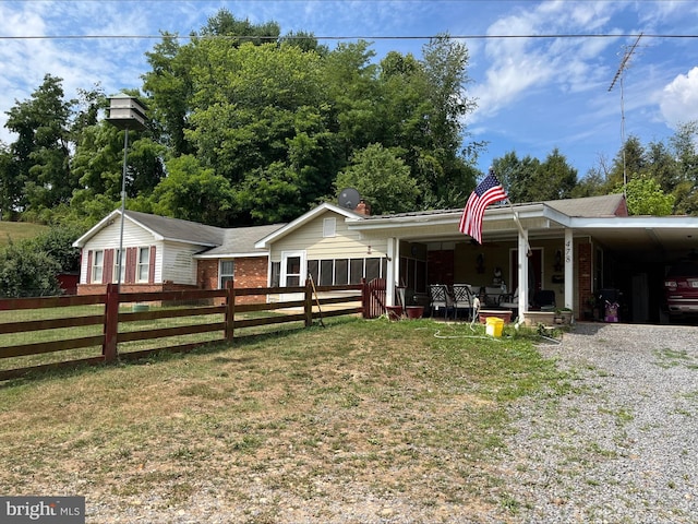 view of front of house featuring a front yard and a carport