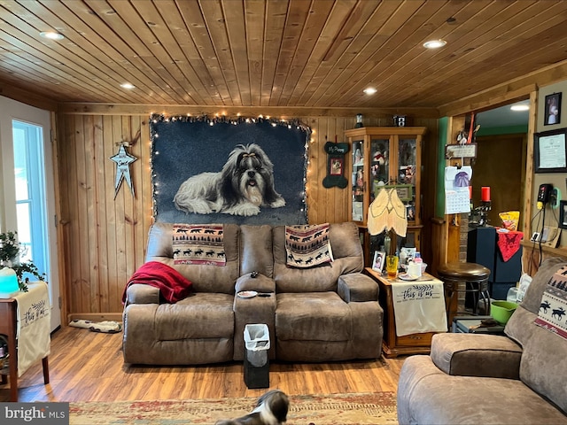 home theater featuring hardwood / wood-style flooring, wood walls, and wood ceiling