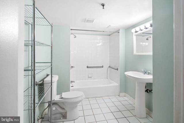 full bathroom featuring tile patterned floors, sink, tiled shower / bath combo, and toilet