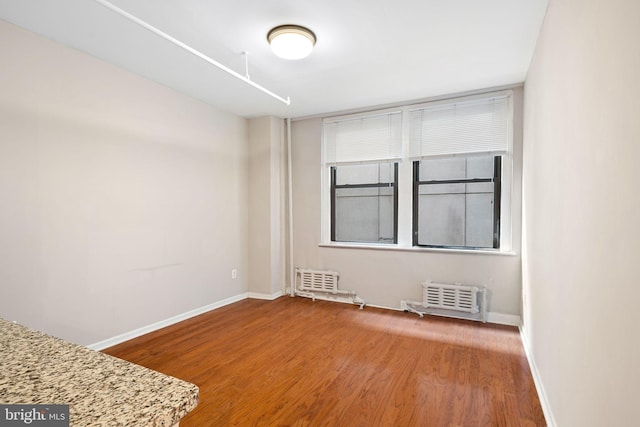 spare room featuring hardwood / wood-style floors