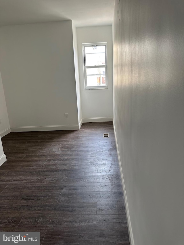 spare room featuring dark hardwood / wood-style floors