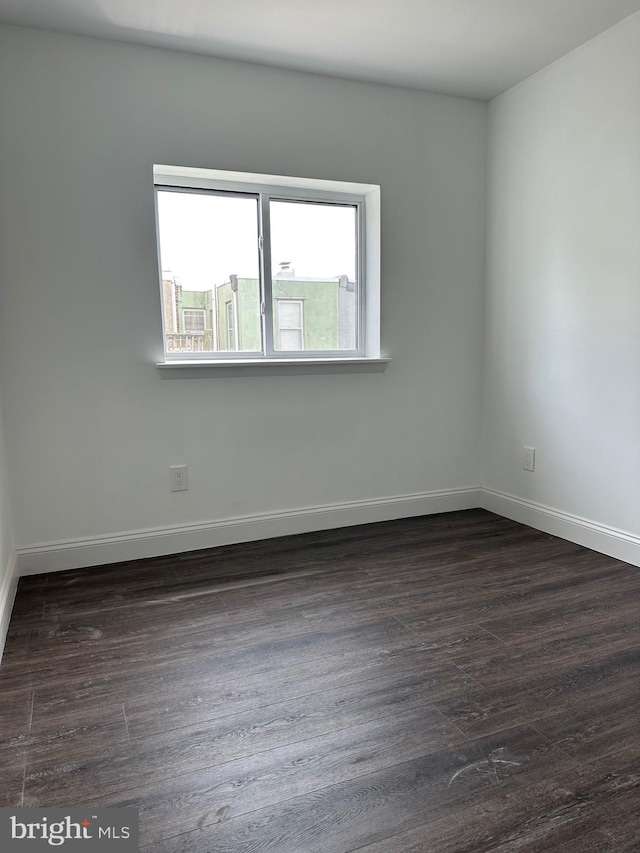 spare room with dark hardwood / wood-style flooring