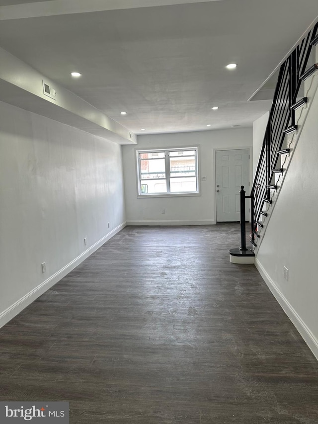 unfurnished living room featuring dark wood-type flooring