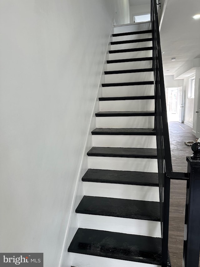 staircase with hardwood / wood-style flooring