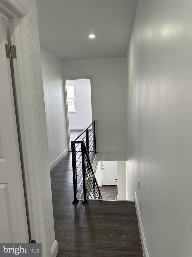 staircase featuring dark hardwood / wood-style floors