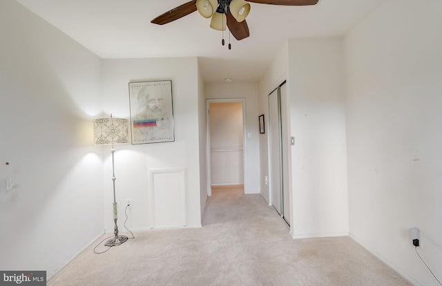 hallway featuring light colored carpet