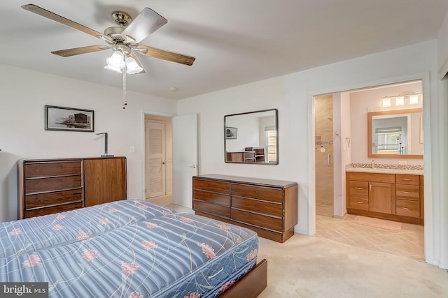 bedroom featuring ensuite bath, ceiling fan, and light colored carpet