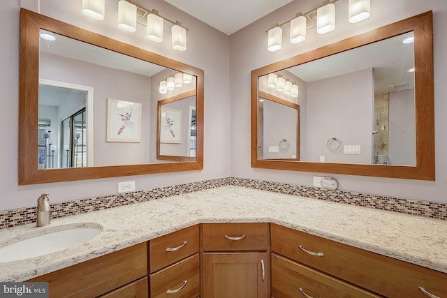 bathroom featuring vanity and backsplash