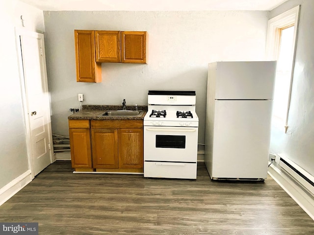 kitchen featuring dark hardwood / wood-style flooring, white appliances, baseboard heating, and sink