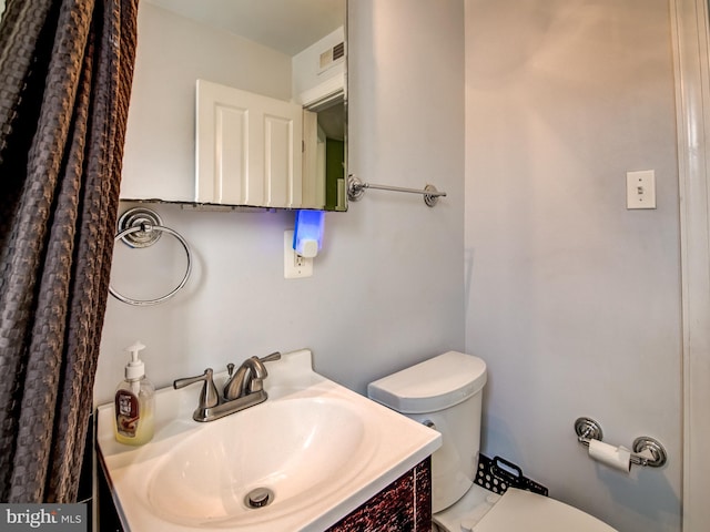 bathroom with vanity and toilet