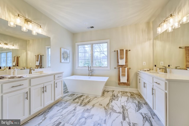 bathroom featuring a washtub and vanity