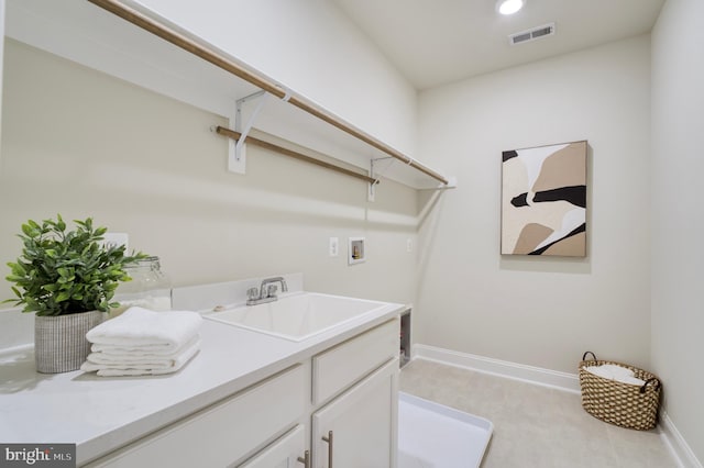 laundry area featuring hookup for a washing machine, cabinets, and sink