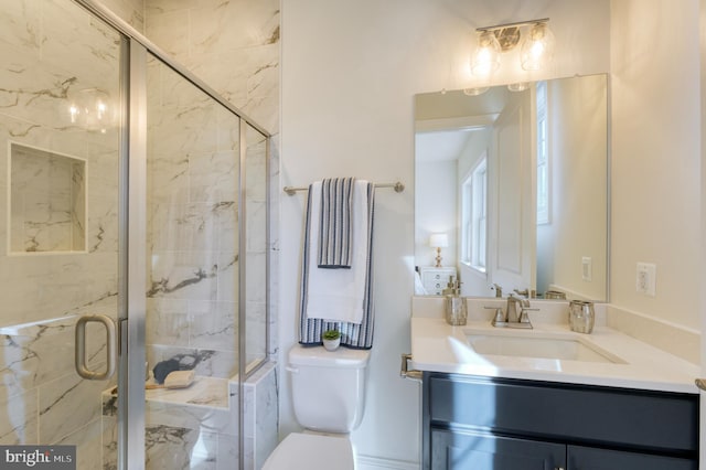 bathroom with vanity, walk in shower, and toilet