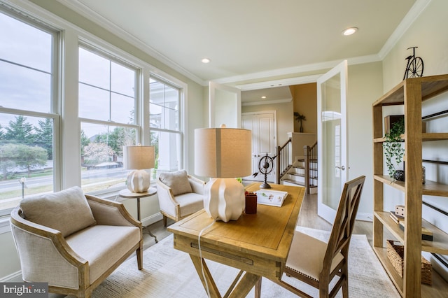 dining room featuring ornamental molding and light hardwood / wood-style flooring