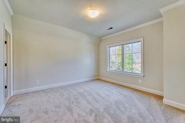 carpeted empty room featuring crown molding