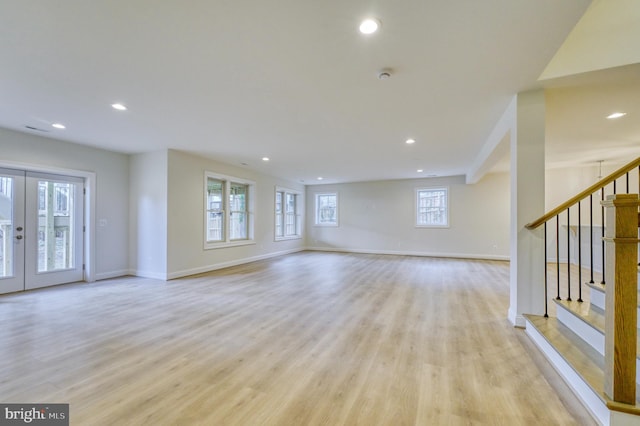 unfurnished living room with light wood-type flooring and a healthy amount of sunlight