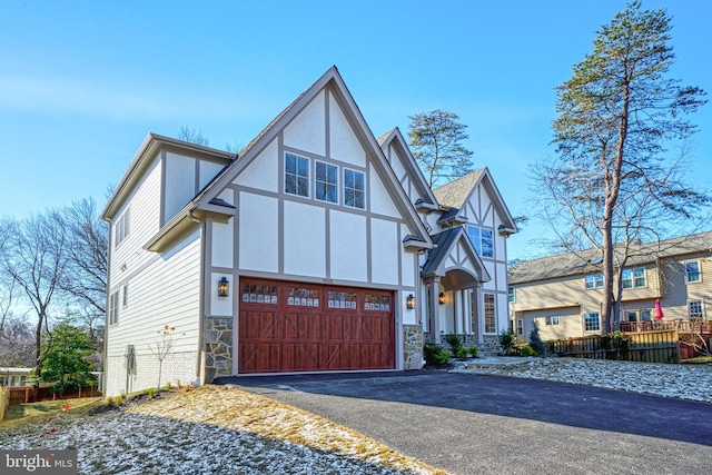 tudor house featuring a garage