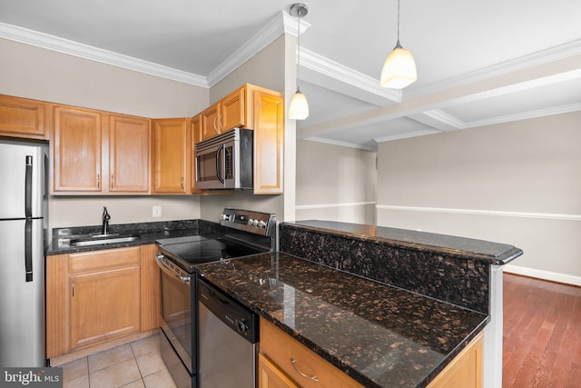 kitchen featuring sink, dark stone countertops, decorative light fixtures, kitchen peninsula, and stainless steel appliances