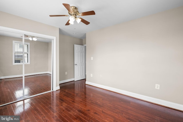 unfurnished bedroom with dark hardwood / wood-style flooring, ceiling fan, and a closet