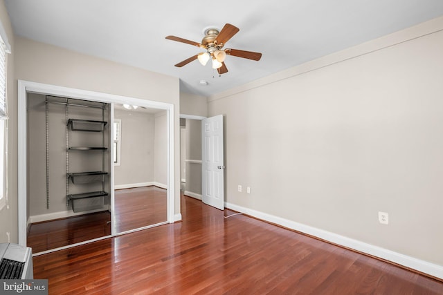 unfurnished bedroom featuring hardwood / wood-style flooring, ceiling fan, and a closet