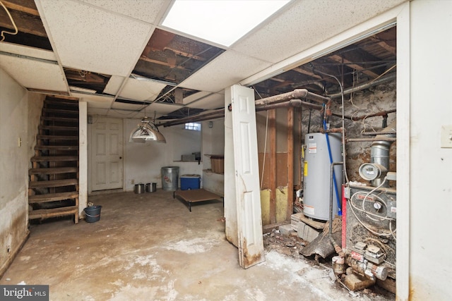 basement with water heater and a drop ceiling