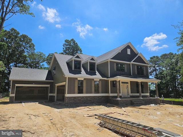 view of front facade with covered porch and a garage