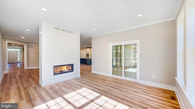 unfurnished living room featuring recessed lighting, a fireplace, baseboards, ornamental molding, and light wood-type flooring