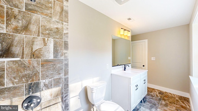 bathroom with toilet, visible vents, baseboards, and vanity