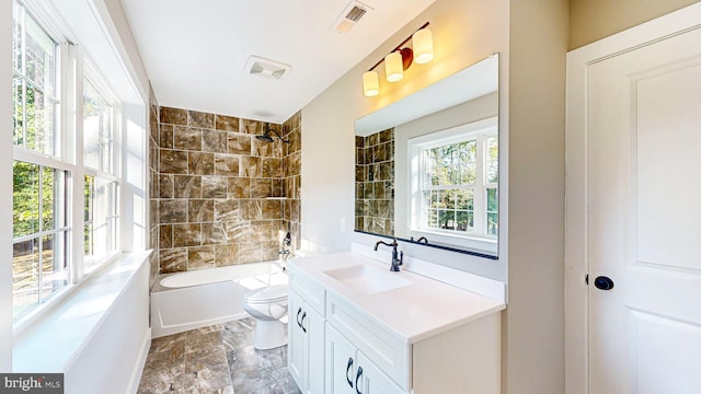 full bath with toilet, shower / bath combination, plenty of natural light, and vanity