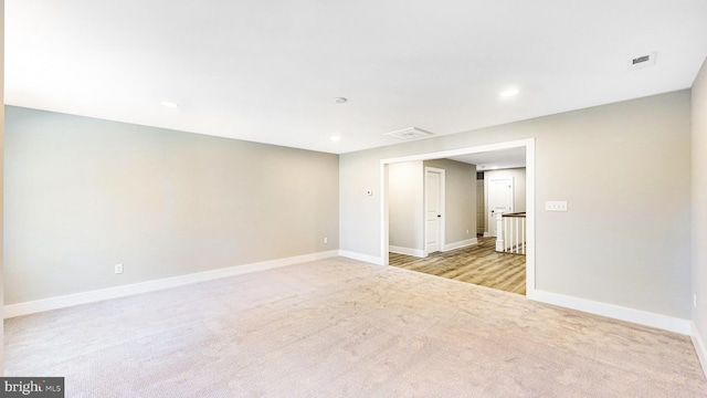 unfurnished room with light carpet, baseboards, visible vents, and recessed lighting