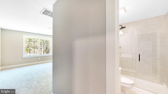 full bathroom featuring a stall shower, baseboards, visible vents, and toilet