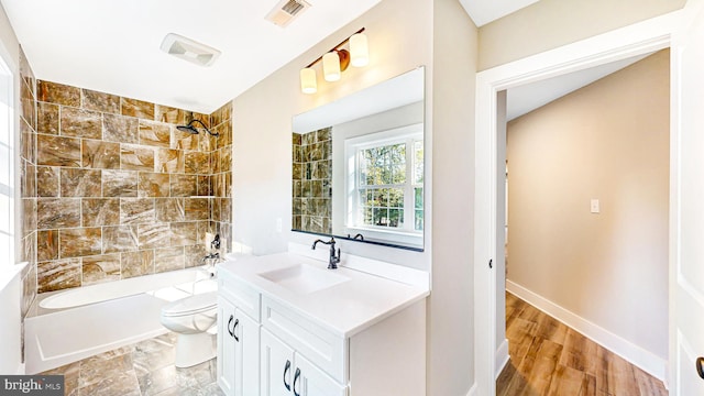 bathroom featuring bathing tub / shower combination, visible vents, toilet, vanity, and baseboards