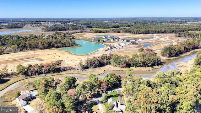 aerial view featuring a water view and a view of trees