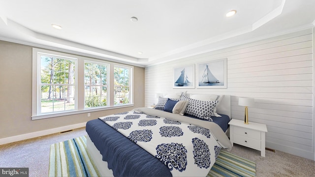 bedroom with light carpet, baseboards, a tray ceiling, and recessed lighting