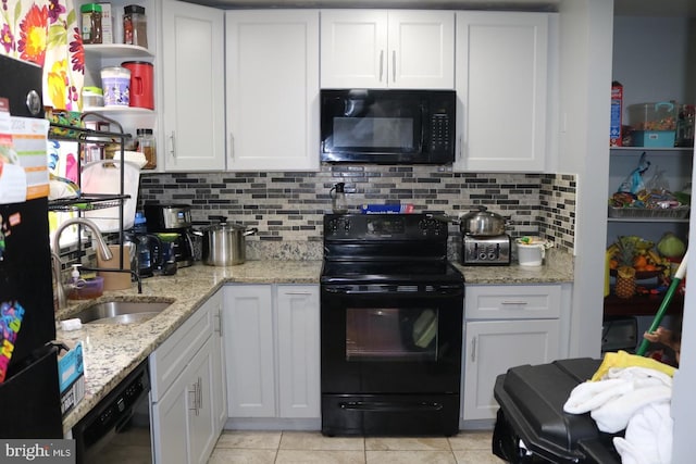 kitchen with decorative backsplash, sink, black appliances, and white cabinetry