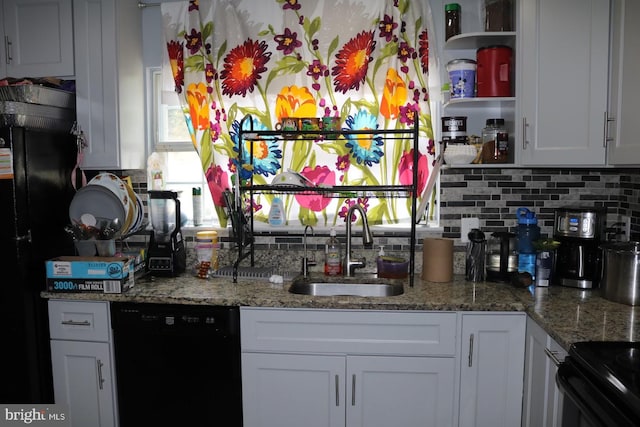 kitchen featuring white cabinets, backsplash, light stone counters, black appliances, and sink